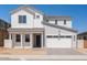 Charming two-story home featuring a white exterior, a two-car garage and a neatly paved driveway at 1350 E Prescott St, Gilbert, AZ 85298