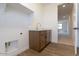 A laundry room with modern wood cabinets and a stainless steel faucet at 1350 E Prescott St, Gilbert, AZ 85298