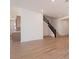 Open living space features wood-look tile floors and modern staircase with black railing at 1350 E Prescott St, Gilbert, AZ 85298