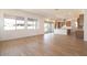 Open-concept living space with wood-look tile floors, large windows, and a view of the modern kitchen at 1350 E Prescott St, Gilbert, AZ 85298