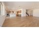 Open-concept living space featuring wood-look tile floors and a view of the modern kitchen at 1350 E Prescott St, Gilbert, AZ 85298