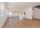 Open living space featuring wood-look tile floors, large windows, and modern staircase with black railing at 1350 E Prescott St, Gilbert, AZ 85298