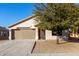 Charming house exterior featuring a two-car garage and landscaped yard at 1628 W San Tan Hills Dr, San Tan Valley, AZ 85144