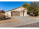 Tan house with two car garage and desert landscaping at 1628 W San Tan Hills Dr, San Tan Valley, AZ 85144