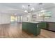 Open concept kitchen with green island and stainless steel appliances at 1628 W San Tan Hills Dr, San Tan Valley, AZ 85144