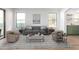 Living room with gray sofa and coffee table, open to kitchen at 1628 W San Tan Hills Dr, San Tan Valley, AZ 85144
