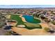 Wide aerial view of a golf course community with many homes at 26573 W Abraham Ln, Buckeye, AZ 85396
