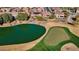 Aerial view showcasing a home near a lake and golf course at 26573 W Abraham Ln, Buckeye, AZ 85396