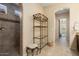 Spa-like bathroom with walk-in shower, glass enclosure, and tiled walls at 26573 W Abraham Ln, Buckeye, AZ 85396
