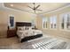 Spacious primary bedroom with ceiling fan and large windows at 26573 W Abraham Ln, Buckeye, AZ 85396