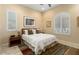 Bright bedroom with a queen-size bed and window shutters at 26573 W Abraham Ln, Buckeye, AZ 85396