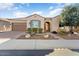 Single-story home with desert landscaping and a 2-car garage at 26573 W Abraham Ln, Buckeye, AZ 85396
