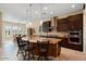 Open kitchen with large island, double oven, and breakfast nook at 26573 W Abraham Ln, Buckeye, AZ 85396
