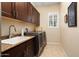 Bright laundry room featuring washer, dryer, and cabinets at 26573 W Abraham Ln, Buckeye, AZ 85396