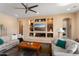 Living room with built-in shelving, a ceiling fan, and comfortable sofas at 26573 W Abraham Ln, Buckeye, AZ 85396