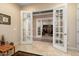 Home office with French doors and view into another room at 26573 W Abraham Ln, Buckeye, AZ 85396
