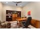 Spacious home office with wood desk and comfortable chair at 26573 W Abraham Ln, Buckeye, AZ 85396