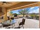 Relaxing patio with seating area, fireplace, and golf course view at 26573 W Abraham Ln, Buckeye, AZ 85396