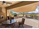 Relaxing patio with seating area, fireplace, and golf course view at 26573 W Abraham Ln, Buckeye, AZ 85396