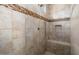 Large walk-in shower with tiled walls and built-in seat at 26573 W Abraham Ln, Buckeye, AZ 85396