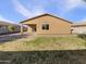 Covered patio and grassy area in the backyard at 37803 W La Paz St, Maricopa, AZ 85138
