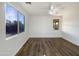 Bright bedroom with wood-look floors and large windows at 37803 W La Paz St, Maricopa, AZ 85138