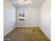 Bright bedroom with carpeted floors and a window at 37803 W La Paz St, Maricopa, AZ 85138