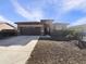 Single-story home with a two-car garage and desert landscaping at 37803 W La Paz St, Maricopa, AZ 85138