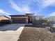 Single-story home with a two-car garage and desert landscaping at 37803 W La Paz St, Maricopa, AZ 85138