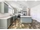 Modern kitchen with light-grey cabinets and a large island at 37803 W La Paz St, Maricopa, AZ 85138
