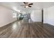 Open living room features wood-look floors and a view into the kitchen at 37803 W La Paz St, Maricopa, AZ 85138