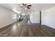 Open living room features wood-look floors and a view of the kitchen at 37803 W La Paz St, Maricopa, AZ 85138