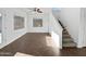 Bright living room with tile floors and stairs to upper level at 37855 W Merced St, Maricopa, AZ 85138