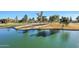 Aerial view of a serene golf course with a calm lake and lush green landscape at 3800 S Cantabria Cir # 1029, Chandler, AZ 85248