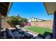 Cozy patio area with comfortable seating, overlooking the landscaped backyard at 6352 W Campo Bello Dr, Glendale, AZ 85308