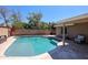 The pristine backyard pool features a tanning shelf and a spacious seating area to relax at 6352 W Campo Bello Dr, Glendale, AZ 85308