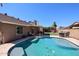 Beautiful backyard pool with a tanning shelf, complemented by a patio area for outdoor enjoyment at 6352 W Campo Bello Dr, Glendale, AZ 85308