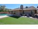 Spacious backyard featuring an outdoor seating area, a covered patio, and a refreshing pool perfect for relaxation at 6352 W Campo Bello Dr, Glendale, AZ 85308