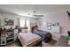 Bedroom featuring two beds, a ceiling fan and a toy kitchen at 6352 W Campo Bello Dr, Glendale, AZ 85308