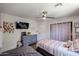 Bedroom with two beds, ceiling fan, and curtains at 6352 W Campo Bello Dr, Glendale, AZ 85308