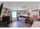 Bedroom features hardwood floors, a daybed, an arcade game and a basketball hoop at 6352 W Campo Bello Dr, Glendale, AZ 85308