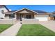 Charming home with a well-kept lawn, solar panels, and a welcoming front entrance, perfect for families at 6352 W Campo Bello Dr, Glendale, AZ 85308