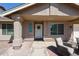 Inviting front porch with an entrance, featuring a textured wall and shaded seating area, perfect for relaxing outdoors at 6352 W Campo Bello Dr, Glendale, AZ 85308