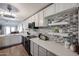 Charming kitchen with stainless steel appliances, decorative backsplash, light-colored cabinets, and plenty of counter space at 6352 W Campo Bello Dr, Glendale, AZ 85308