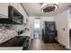 Elegant kitchen featuring stainless steel appliances, decorative backsplash, light cabinets, and direct view to the dining area at 6352 W Campo Bello Dr, Glendale, AZ 85308