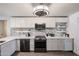Contemporary kitchen design showcasing a sleek island, stainless steel appliances, a gray backsplash, and recessed lighting at 6352 W Campo Bello Dr, Glendale, AZ 85308