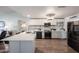 Modern kitchen featuring a center island, stainless steel appliances, and stylish backsplash, offering ample counter space at 6352 W Campo Bello Dr, Glendale, AZ 85308