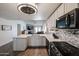 Bright kitchen featuring stainless steel appliances, light gray cabinets, a decorative backsplash, and an open layout at 6352 W Campo Bello Dr, Glendale, AZ 85308