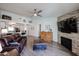 Open concept living room featuring a stone fireplace, wooden accents, and comfortable seating at 6352 W Campo Bello Dr, Glendale, AZ 85308
