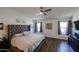 Bright main bedroom featuring a ceiling fan, large bed, and ample natural light from the windows at 6352 W Campo Bello Dr, Glendale, AZ 85308